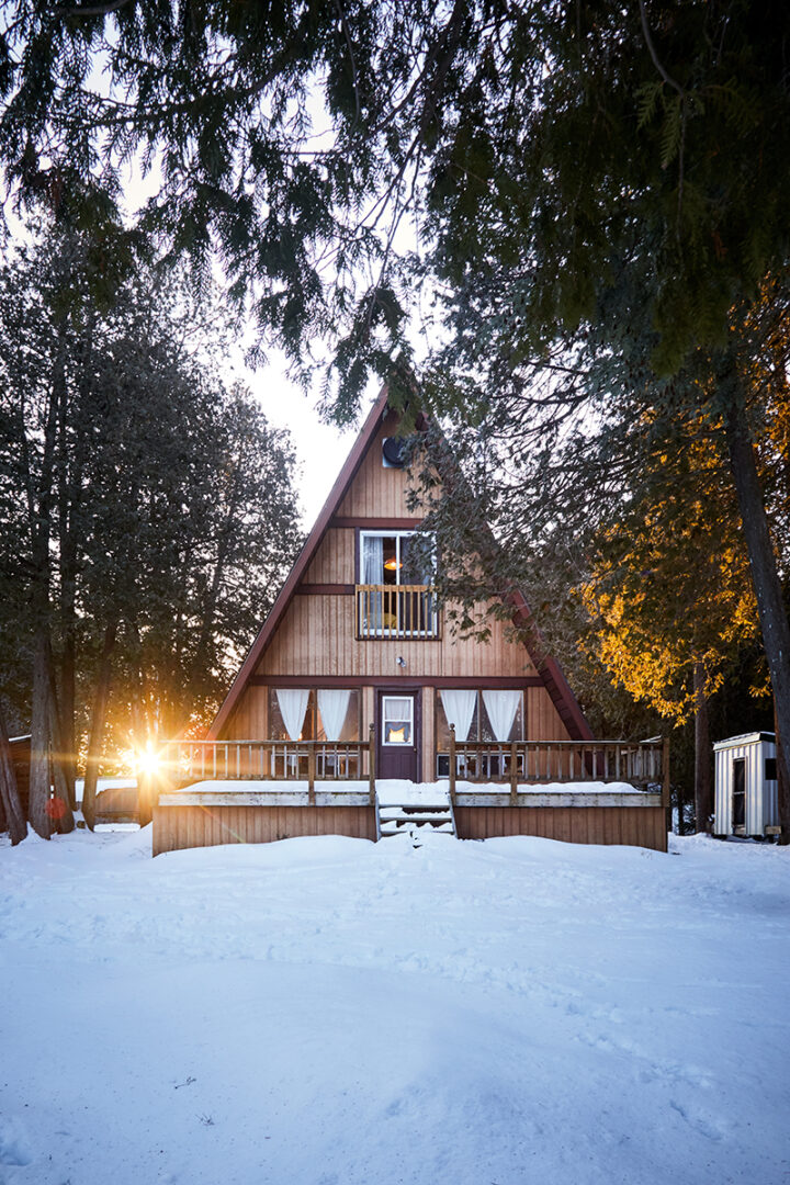 outside shot of A-frame cottage in the snow