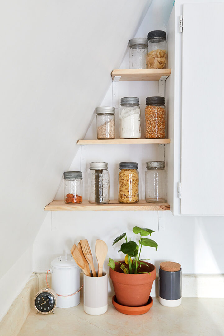 pantry shelves built into the wall in a-frame kitchen