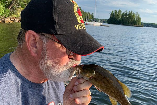 man kissing a fish, love