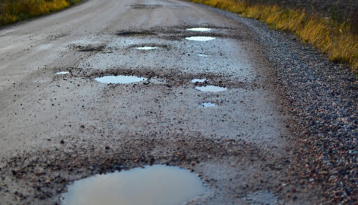 gravel road with pot holes