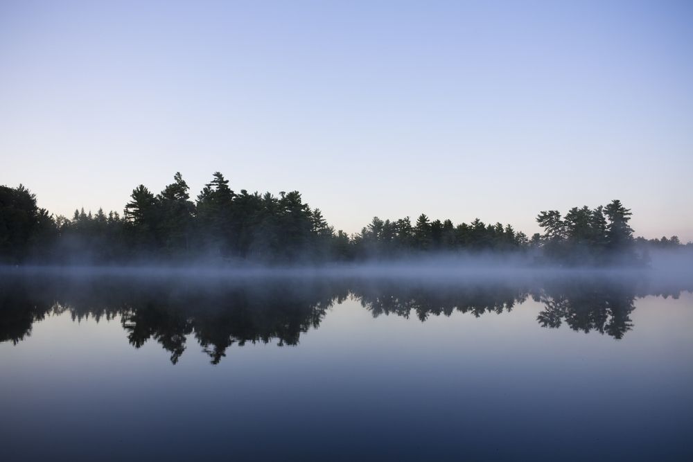 Calm misty cottage lake