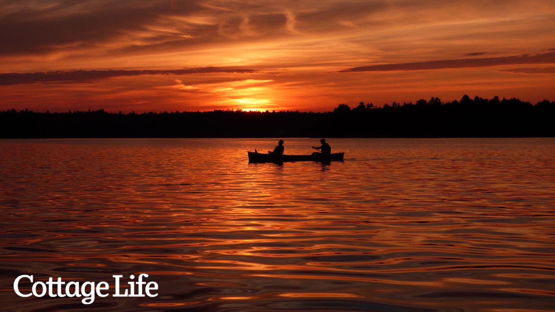 Canoe on a lake at sunset