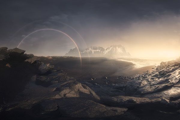 rainbow in the distance over mountains in Iceland