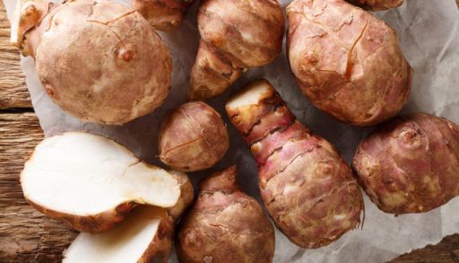 Jerusalem artichoke also called sunroot, sunchokes, earth apple, or topinambour close-up on the table. horizontal top view from above