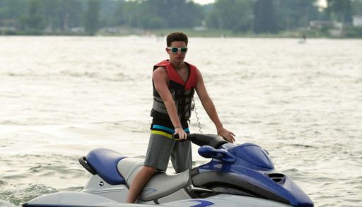 A teen boy on a PWC on the lake