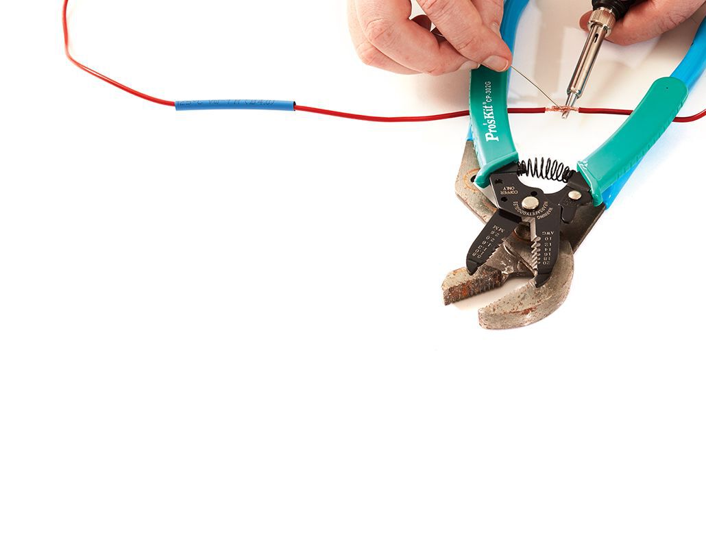 two hand soldering a wire on a white background, solder