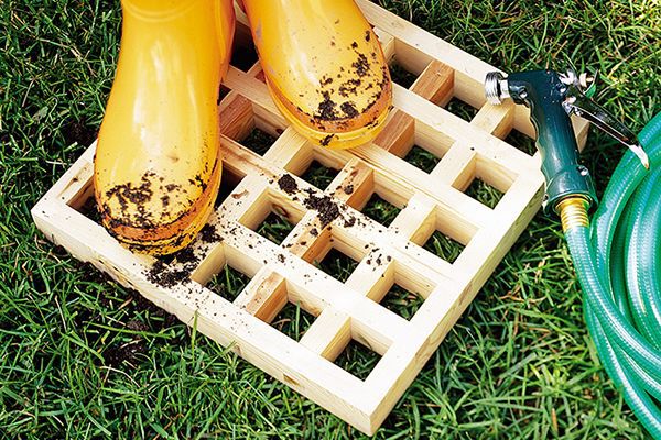 yellow rubber boots on a wooden boot washing grate, project