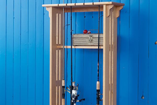 wooden fishing rod rack project on a blue wall