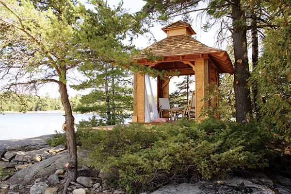 wooden gazebo project sitting on a rock in the distance