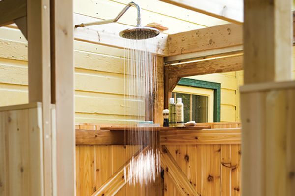 wooden outdoor shower project with showerhead turned on