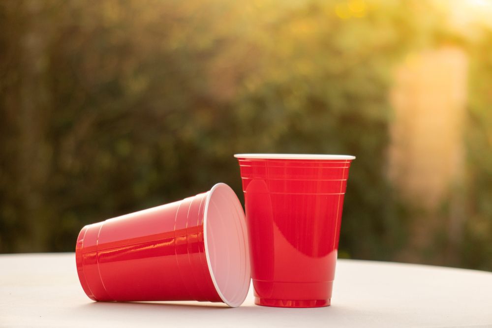 Two red solo cups on a white table