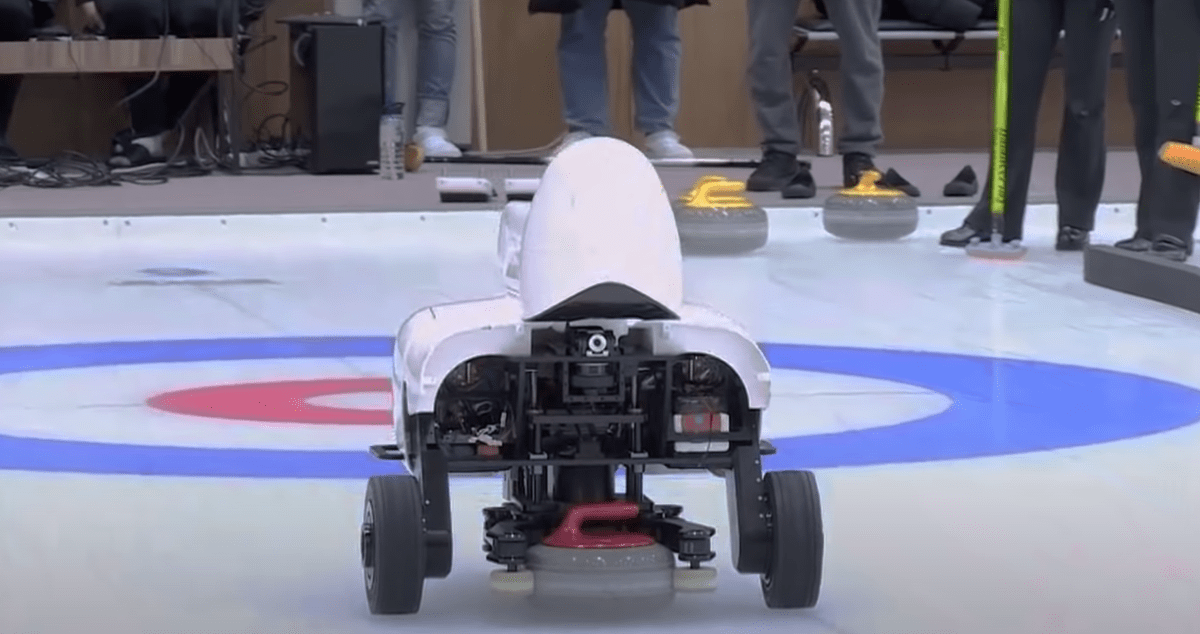 curly the AI curling robot throwing a rock down the ice
