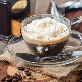 Coffee with whipped cream in glass mugs
