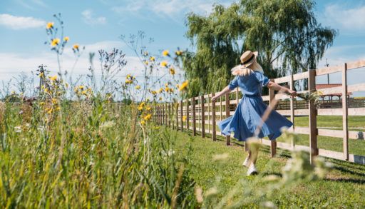Cottagecore Farmcore Countrycore aesthetics, fresh air, countryside, slow life, pastoral life, outdoor picnics, wearing grandma clothes. Young girl in straw hat with flowers walks on country farm