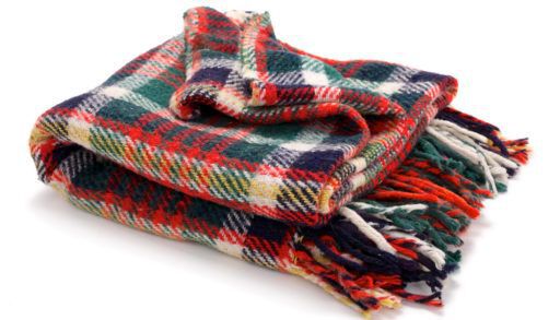 A folded wool blanket against a white background