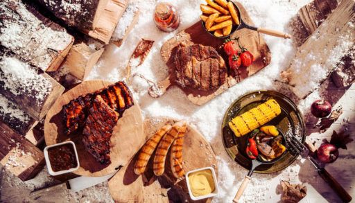 A spread of grilled food against a snowy background