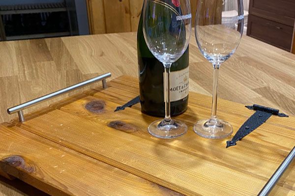 old cabinet door made into a serving tray with champagne and glasses on top, upcycle