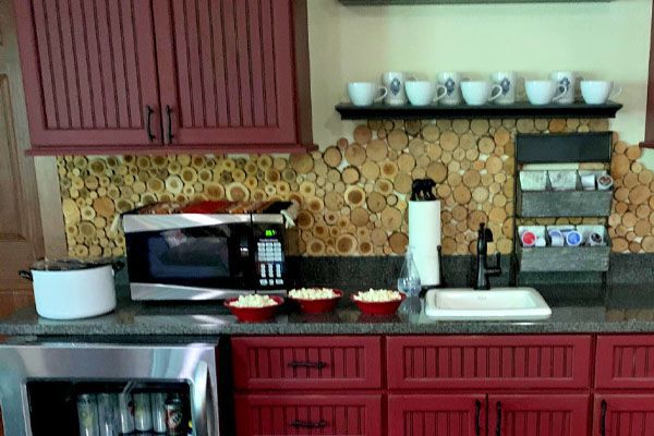 kitchen with wood slices being used as kitchen backsplash
