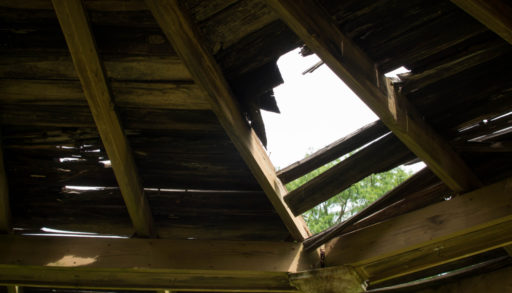 A wooden roof with a hole it in