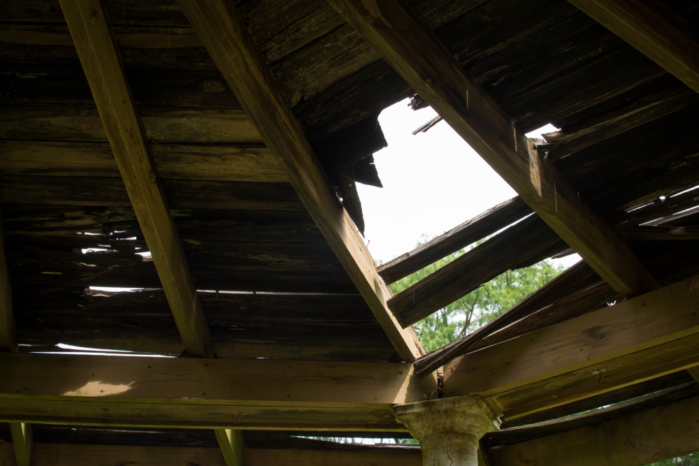 A wooden roof with a hole it in
