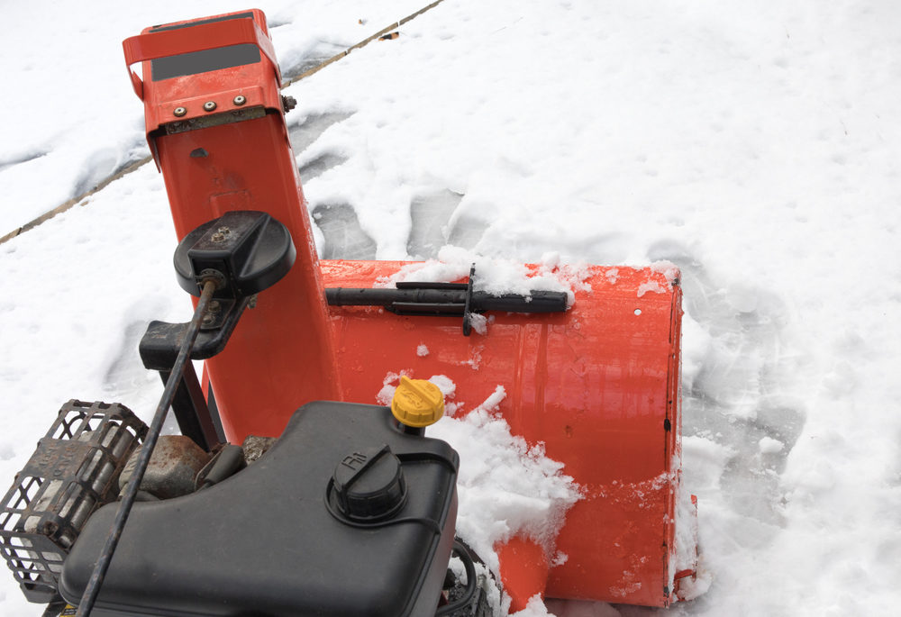 looking forward to the engine and snow chute of an orange snow blower