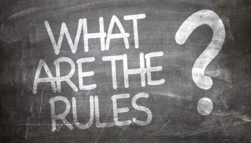 The words "What are the rules?" written in chalk