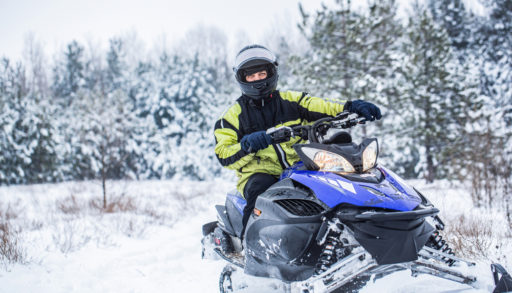 man snowmobiling in cottage country