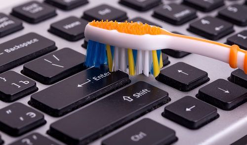 keyboard cleaning with toothbrush