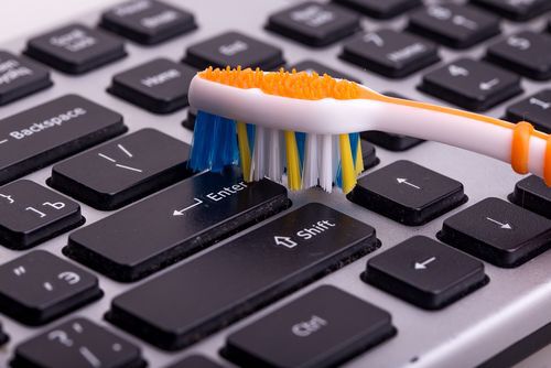keyboard cleaning with toothbrush