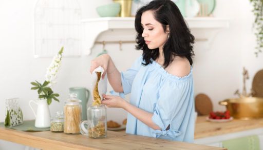 a woman sets up a zero-waste cottage kitchen