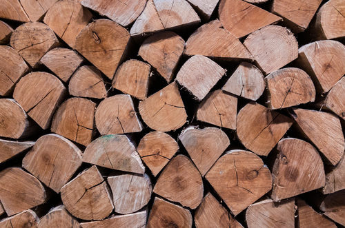 Stack of firewood prepared for winter. Closed up red softwood.