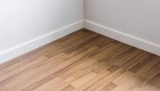A laminate floor against white walls