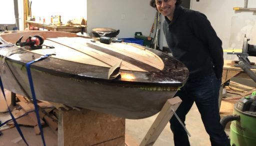 Man standing with DIY boat