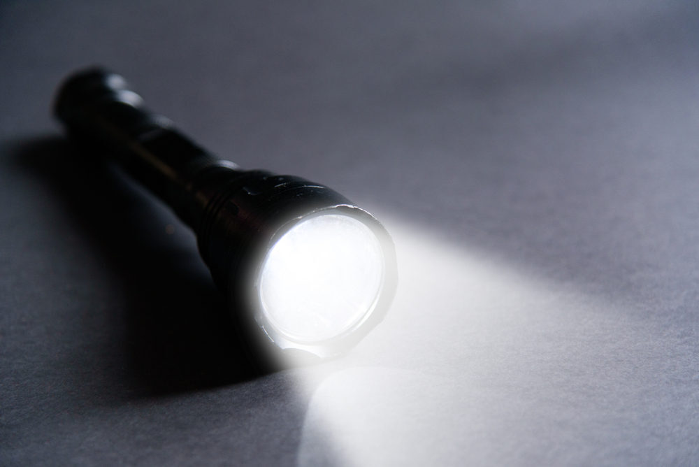 A flashlight lying on a table.