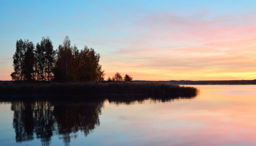 A sunset shot of a cottage lake