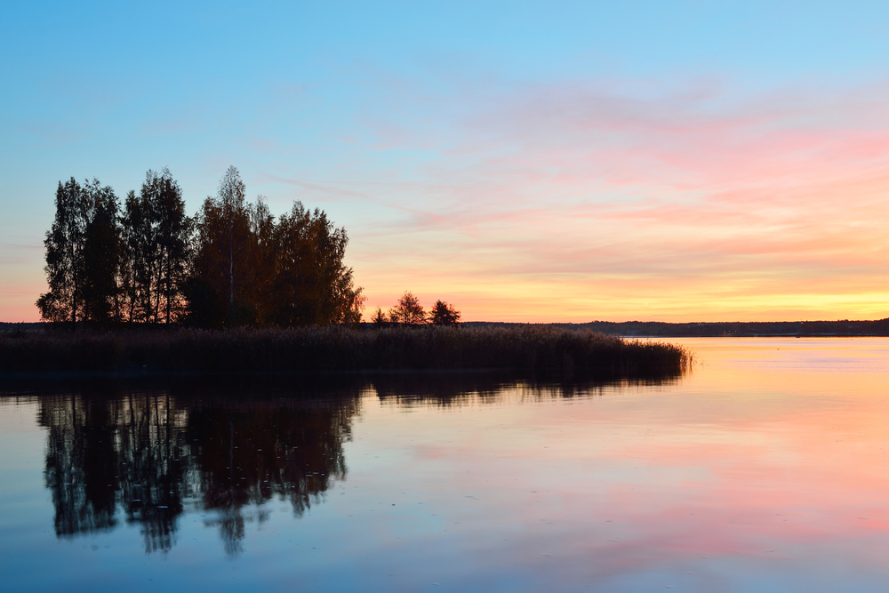 A sunset shot of a cottage lake
