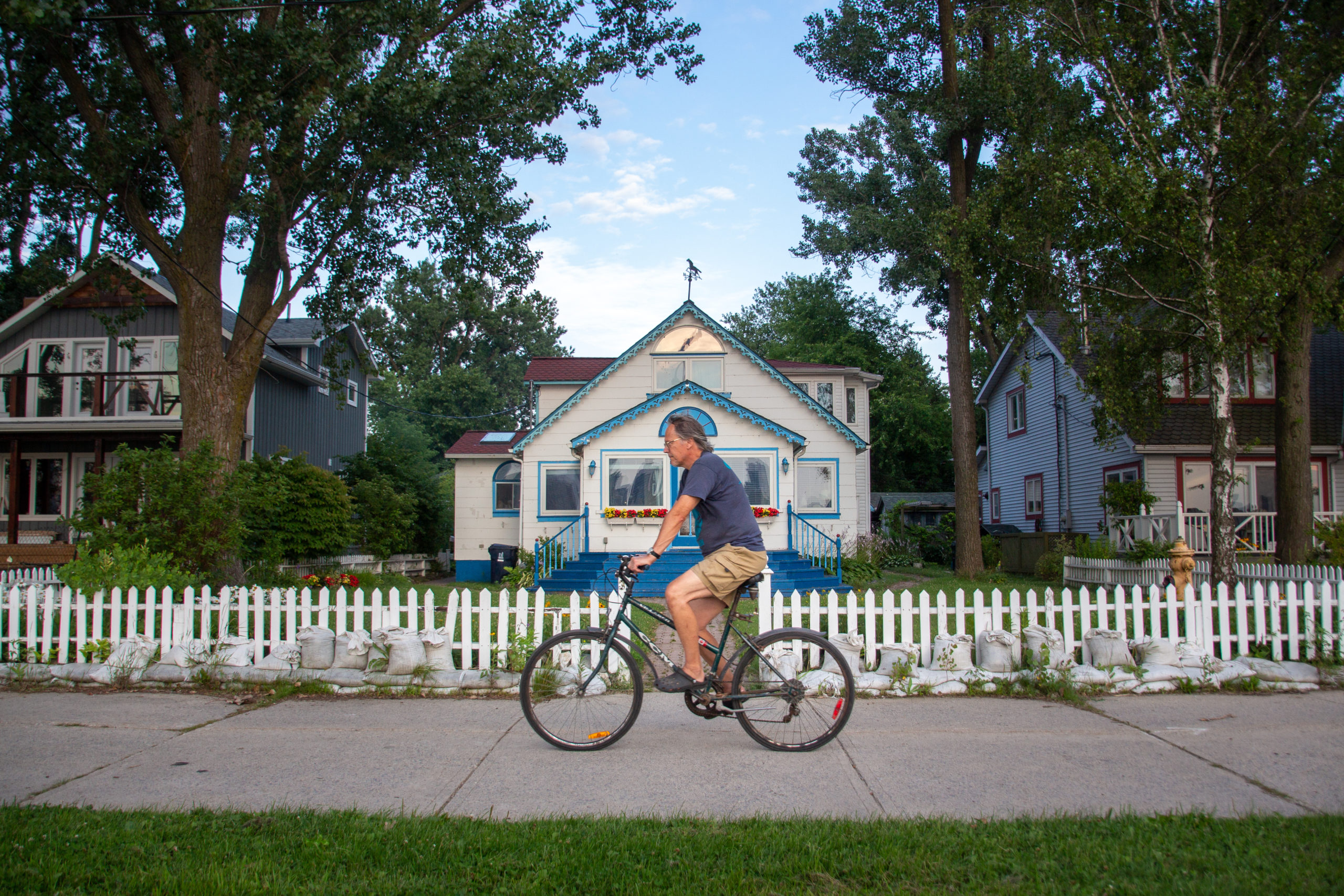 Man biking in front of cottage