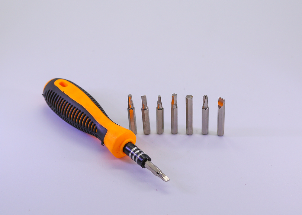 A multi-bit screwdriver with different heads, hand tools
