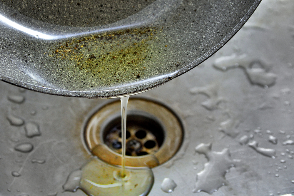 Oil poured into the kitchen sink from a pan, septic tank