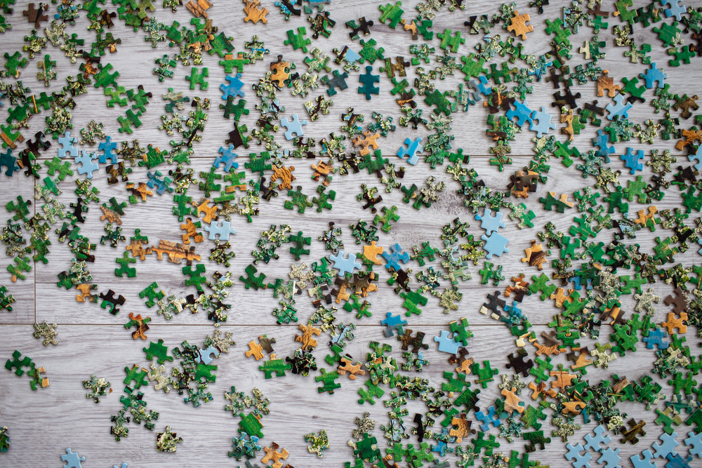 Puzzle pieces scattered on table