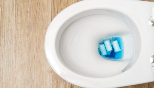 Close-up of a toilet bowl clogged with personal hygiene products, septic tank