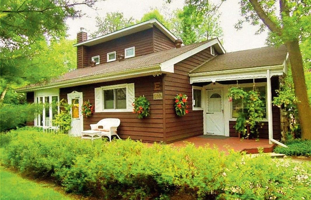 Outside of a brown, log cabin-type cottage