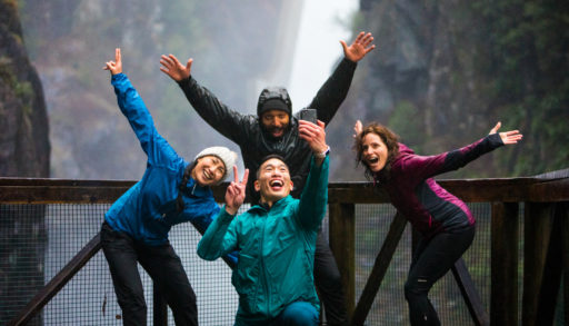 A group of hikers taking a selfie in front of a Trans Canada Trail waterfall