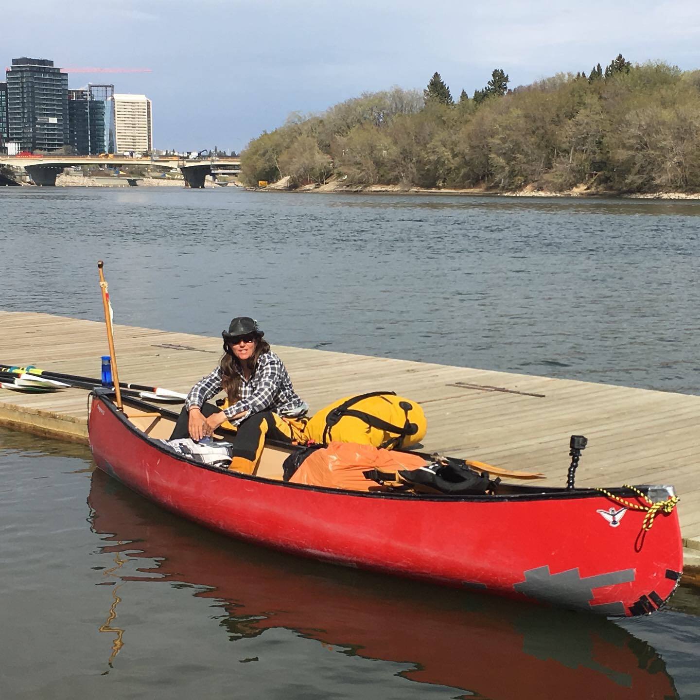 Dianne sitting on the dock with her feet in the boat