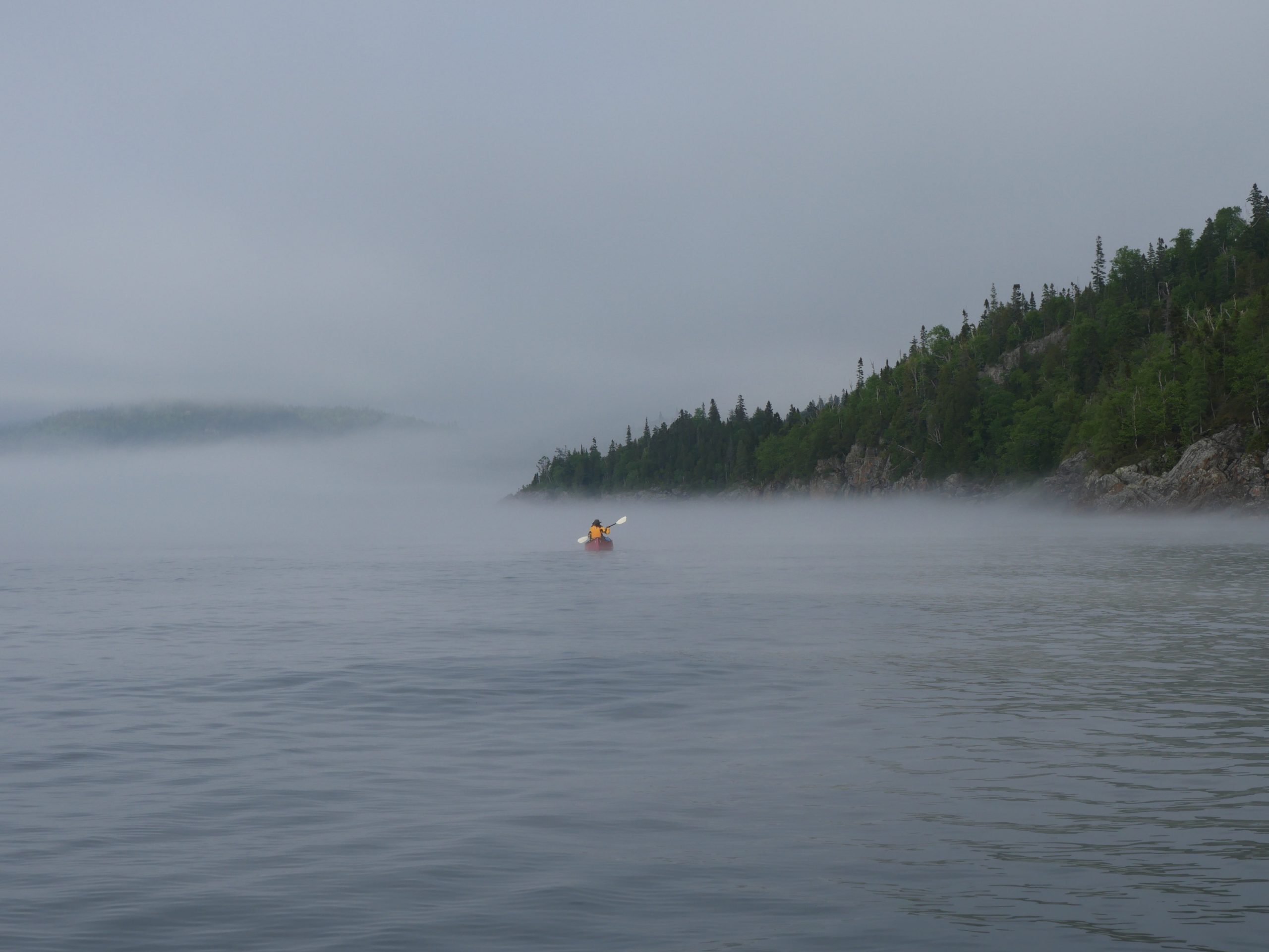 Dianne solo paddling in lake superior