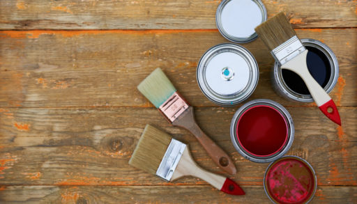 Paint cans and brushes on a old wooden background, painting