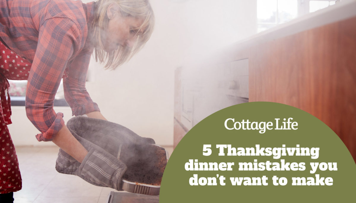 Woman pulling smoking dish out of the oven