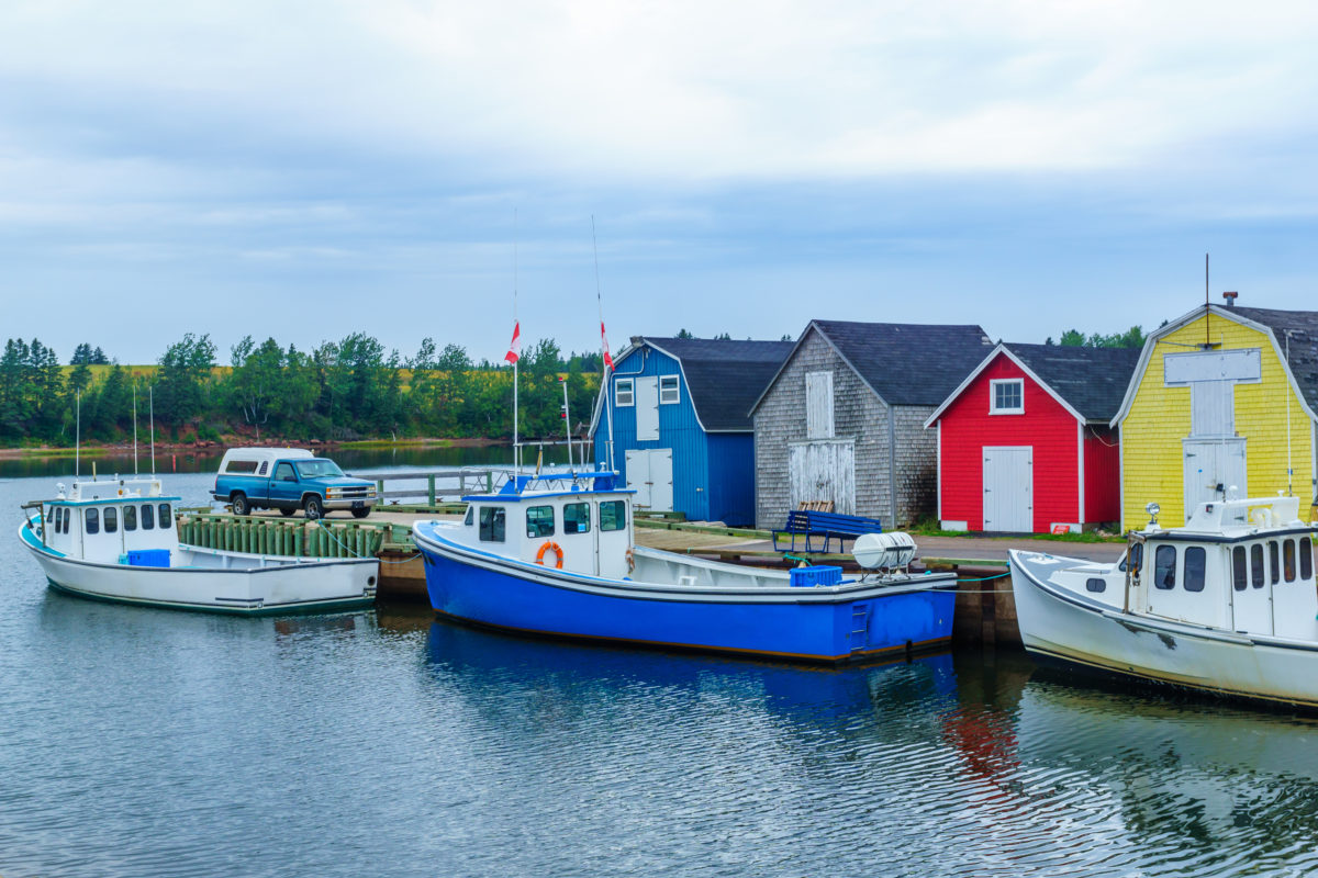 View of pier, fishing boats and colorful houses, in New London, P.E.I.