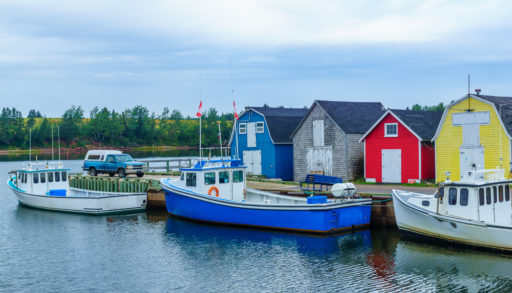 View of pier, fishing boats and colorful houses, in New London, P.E.I.