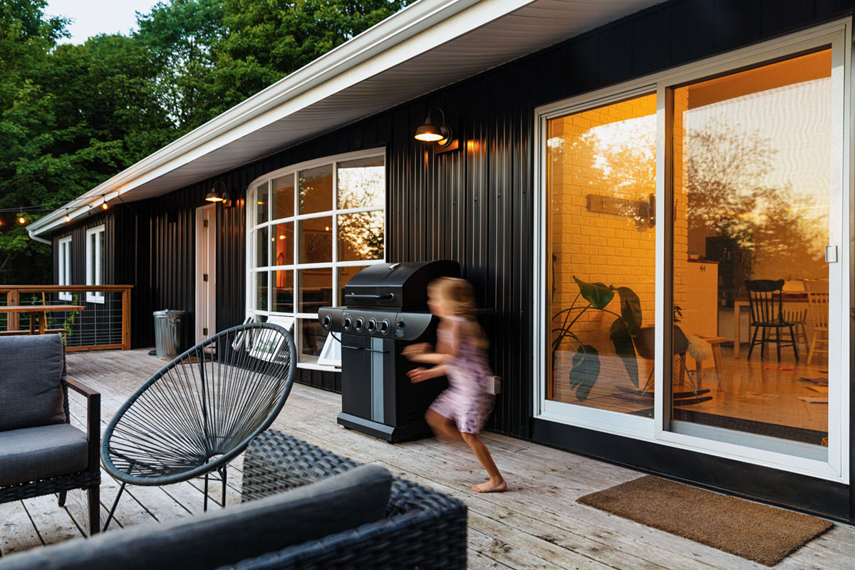 black exterior and deck of Raina and Wilson's share cottage